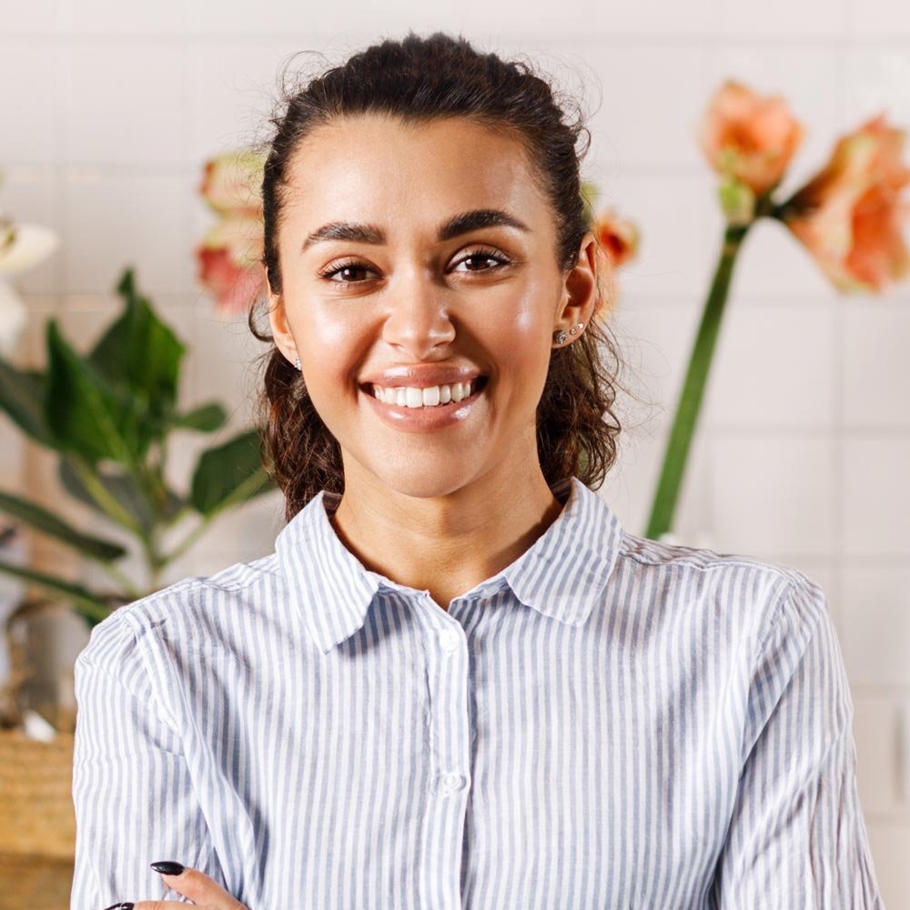 happy-flower-shop-owner-standing-at-counter-2023-09-04-22-29-08-utc.jpg